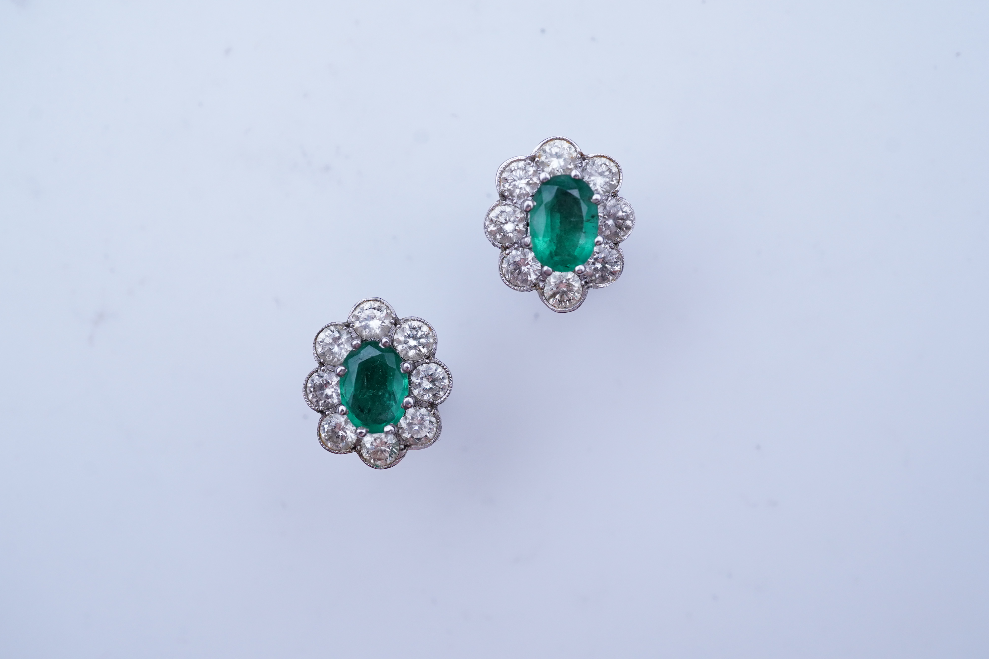 A pair of emerald and diamond earrings